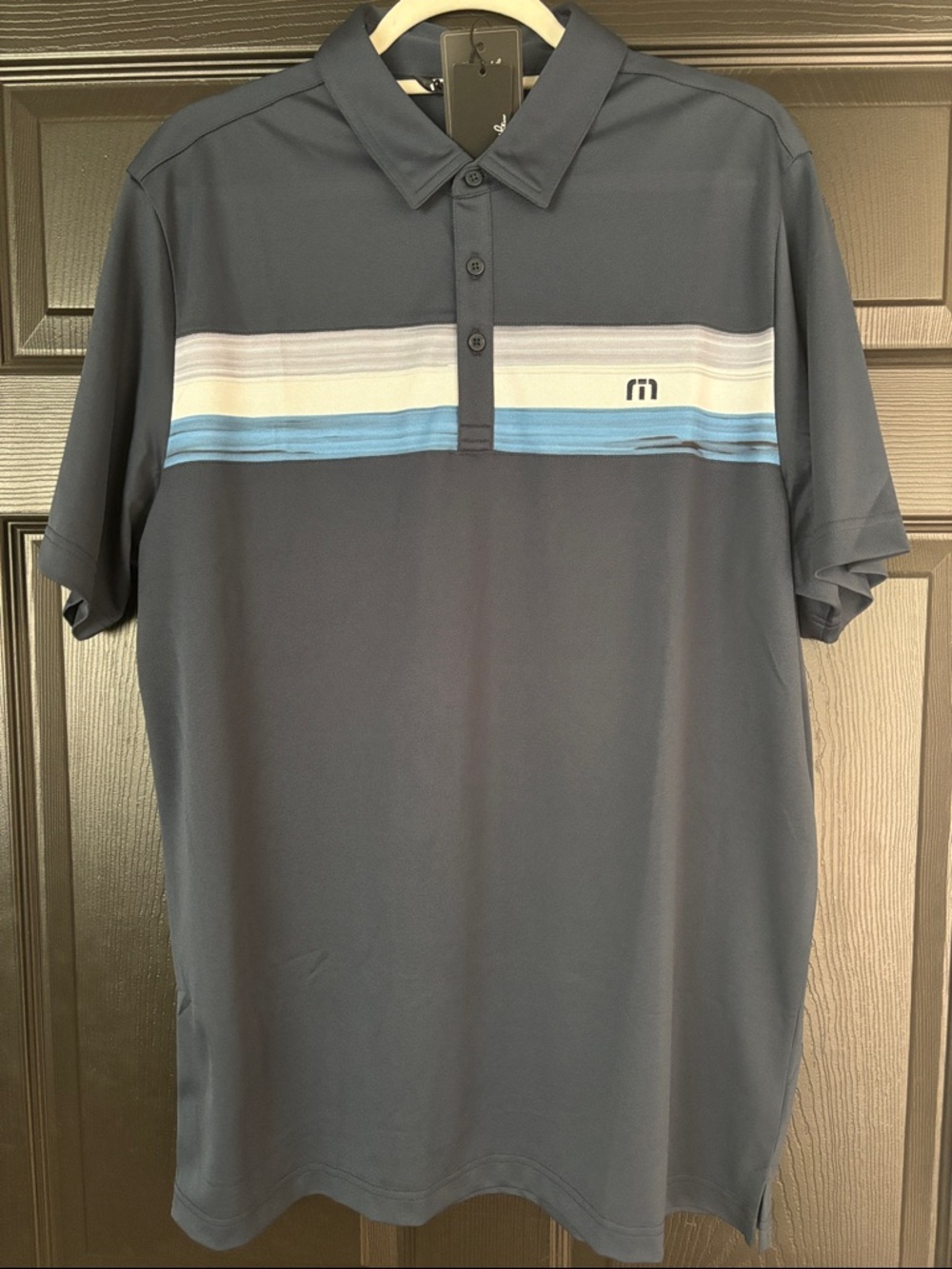 Travis Mathew Navy Polo with Light Blue and White Chest Stripes